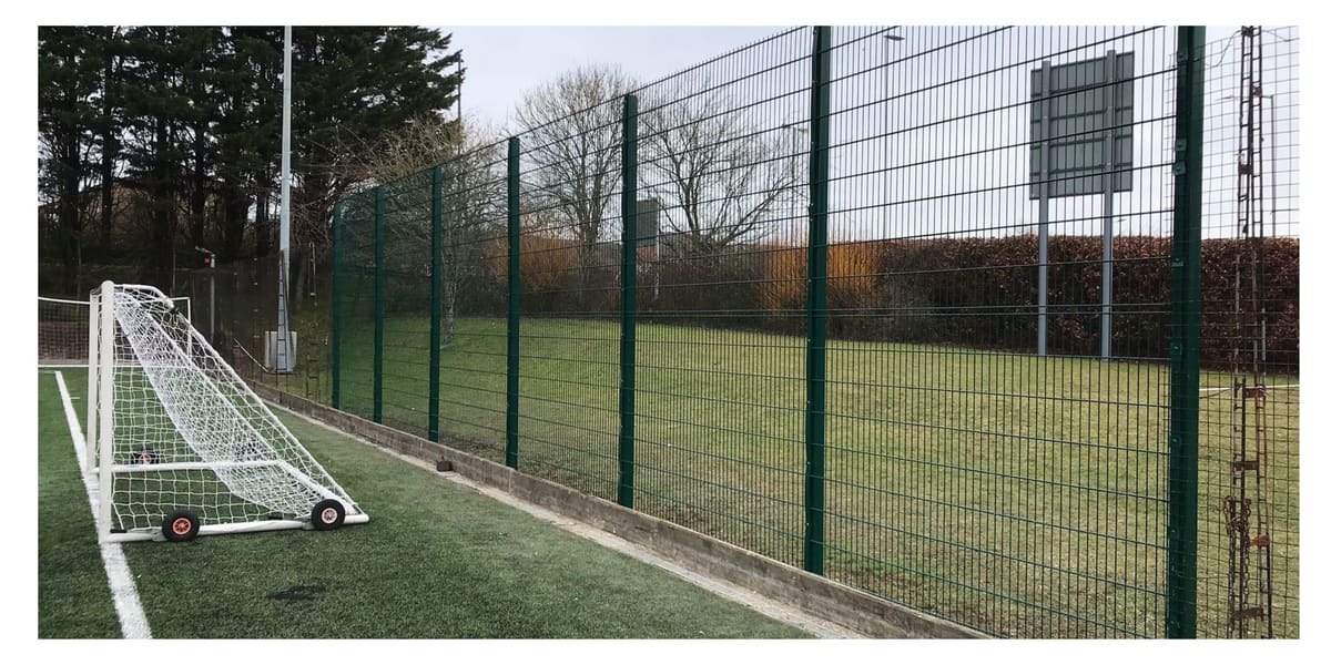 Mesh fencing installed on a park football pitch